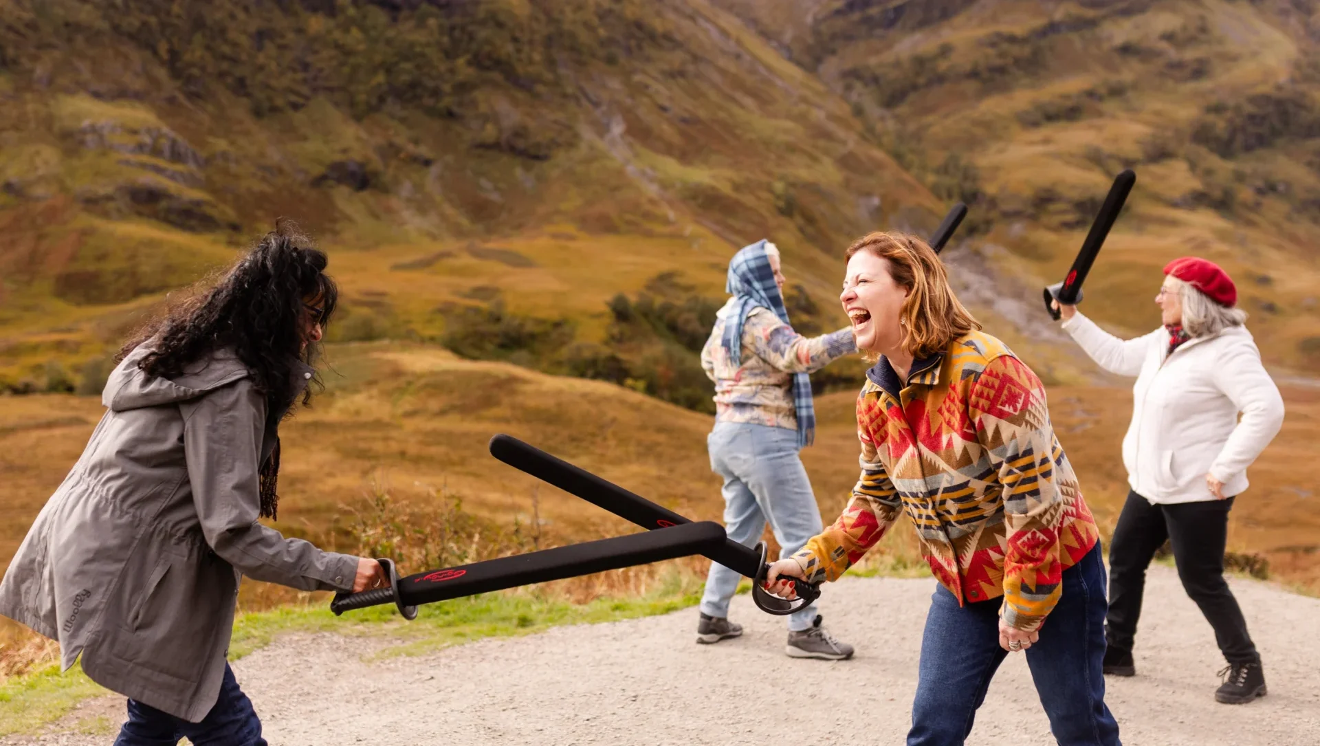 The Real Story of Tartan: A Women Supporting Women Morning at Prickly Thistle 6 People playfully sword fighting outdoors. glencoe outlander