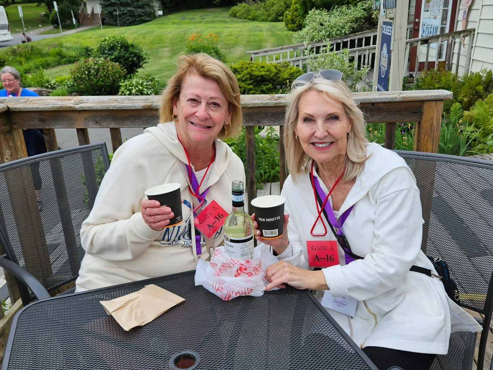 women on a group tour smiling and drinking wine