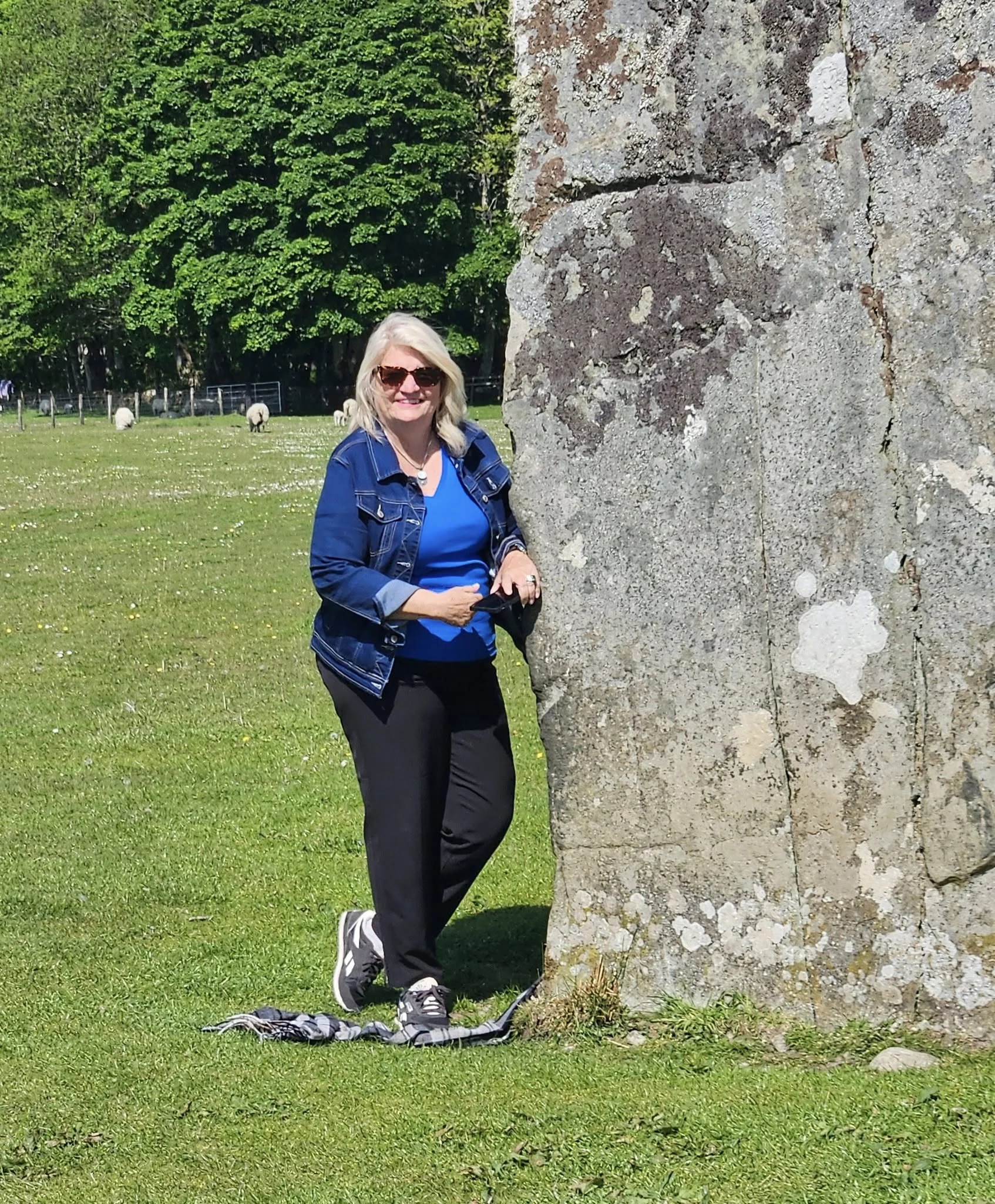 woman standing by a large rock myths about traveling abroad