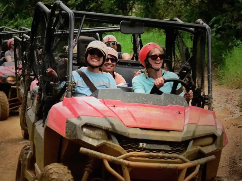 Sisterhood Travels Punta Cana Women ATV riding through a muddy path V08 1920 1 e1686937338141 | Solo Travel For Women | Sisterhood Travels Group Tours