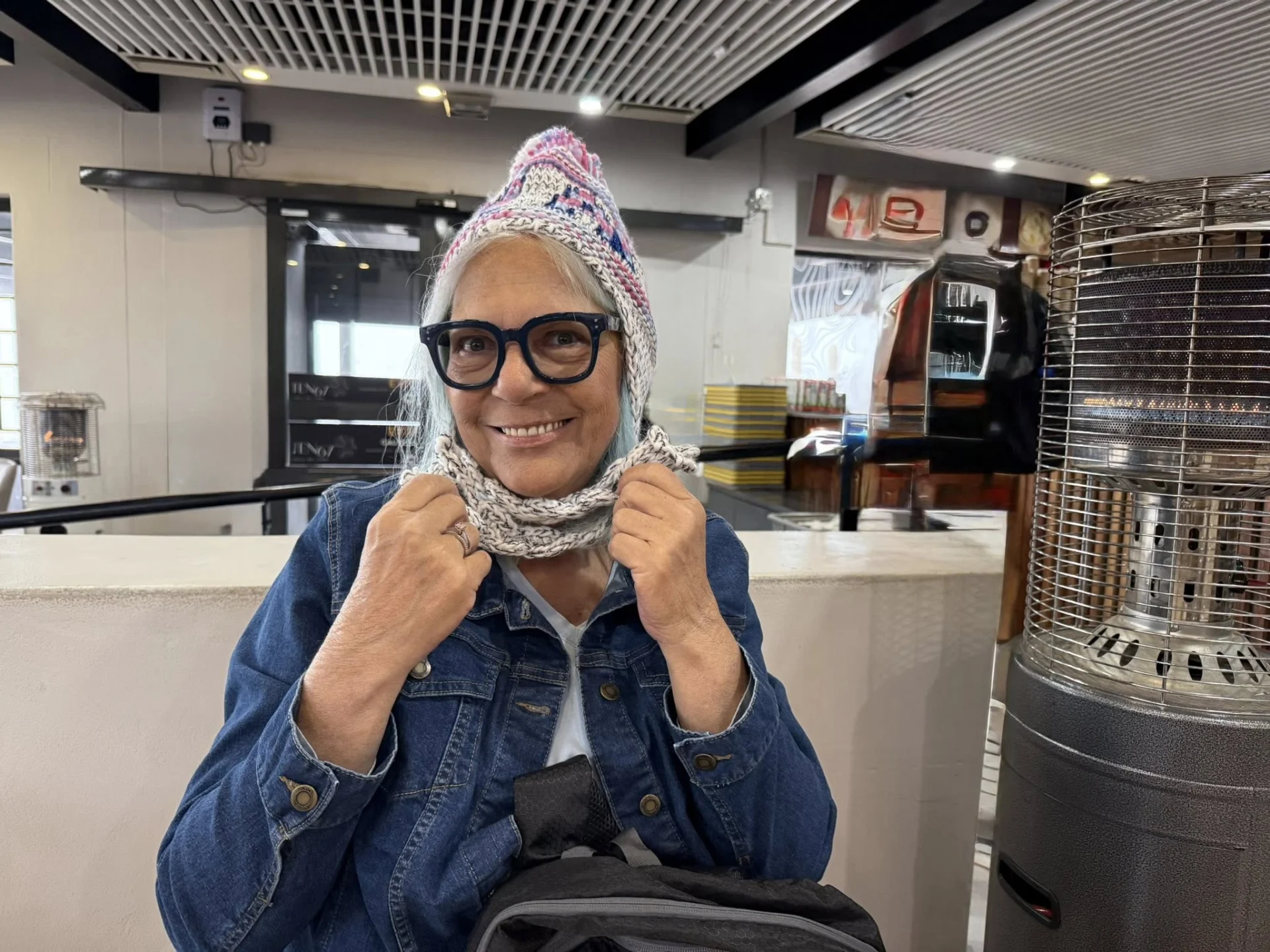 woman smiling and wearing a scarf