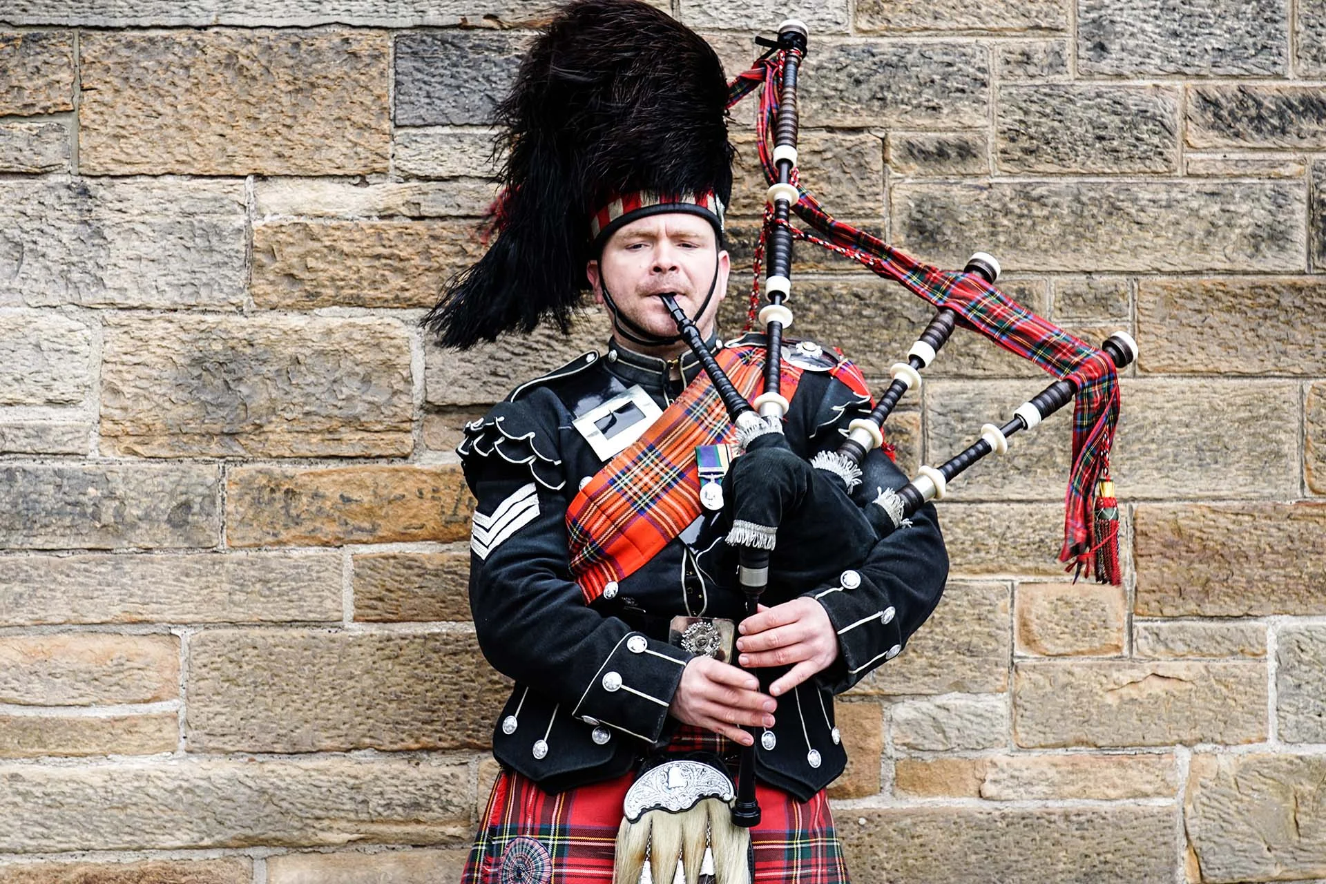 The Real Story of Tartan: A Women Supporting Women Morning at Prickly Thistle 4 Man playing bagpipes in traditional attire